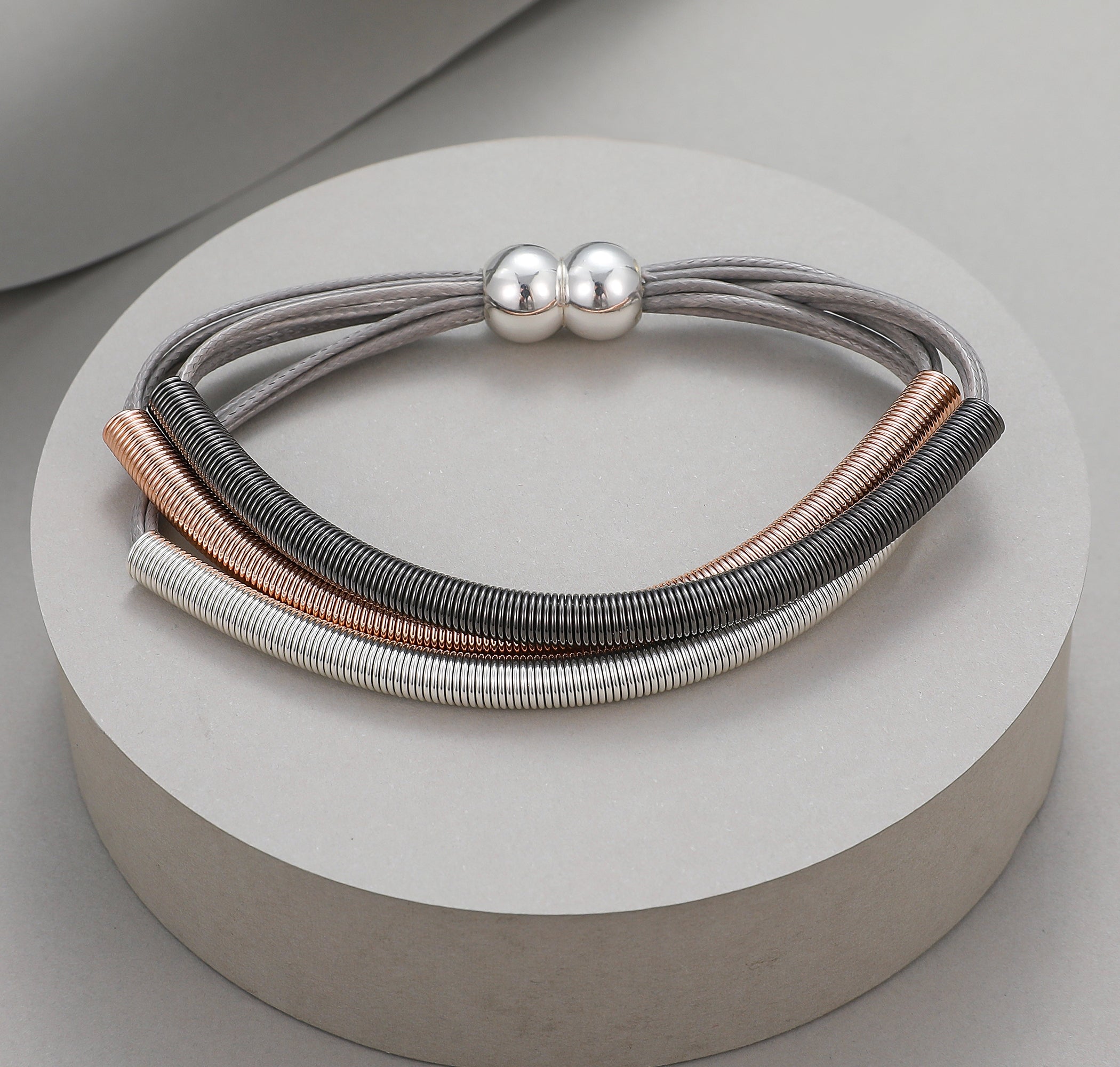 Magnetic bracelet with rose gold, silver and pewter flexible coiled wire