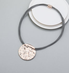 Short magnetic necklace with shiny rose gold circular pendant