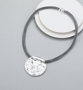 Short magnetic necklace with shiny silver circular pendant