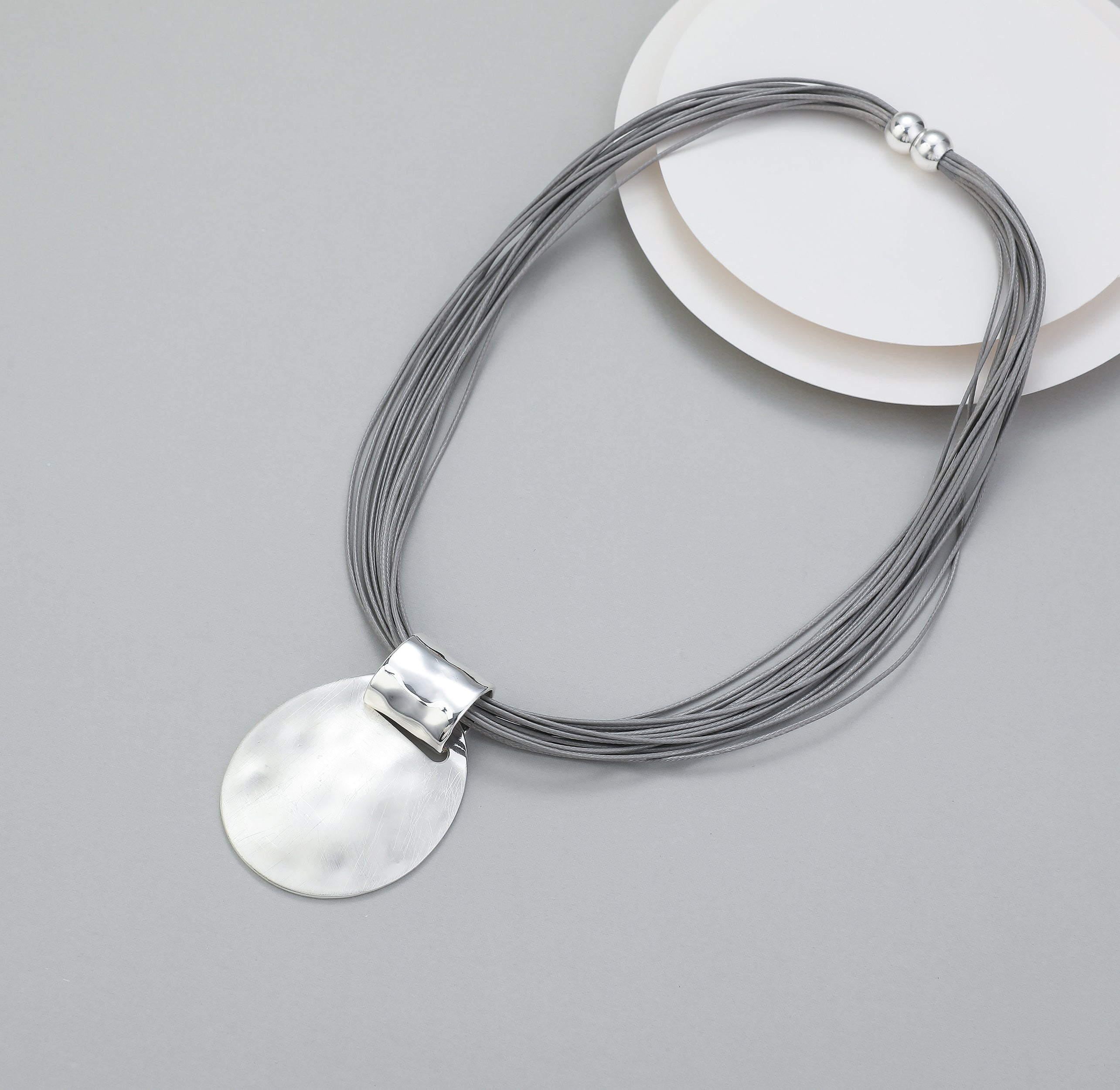 Short magnetic necklace with shiny silver connector and matte silver oval pendant