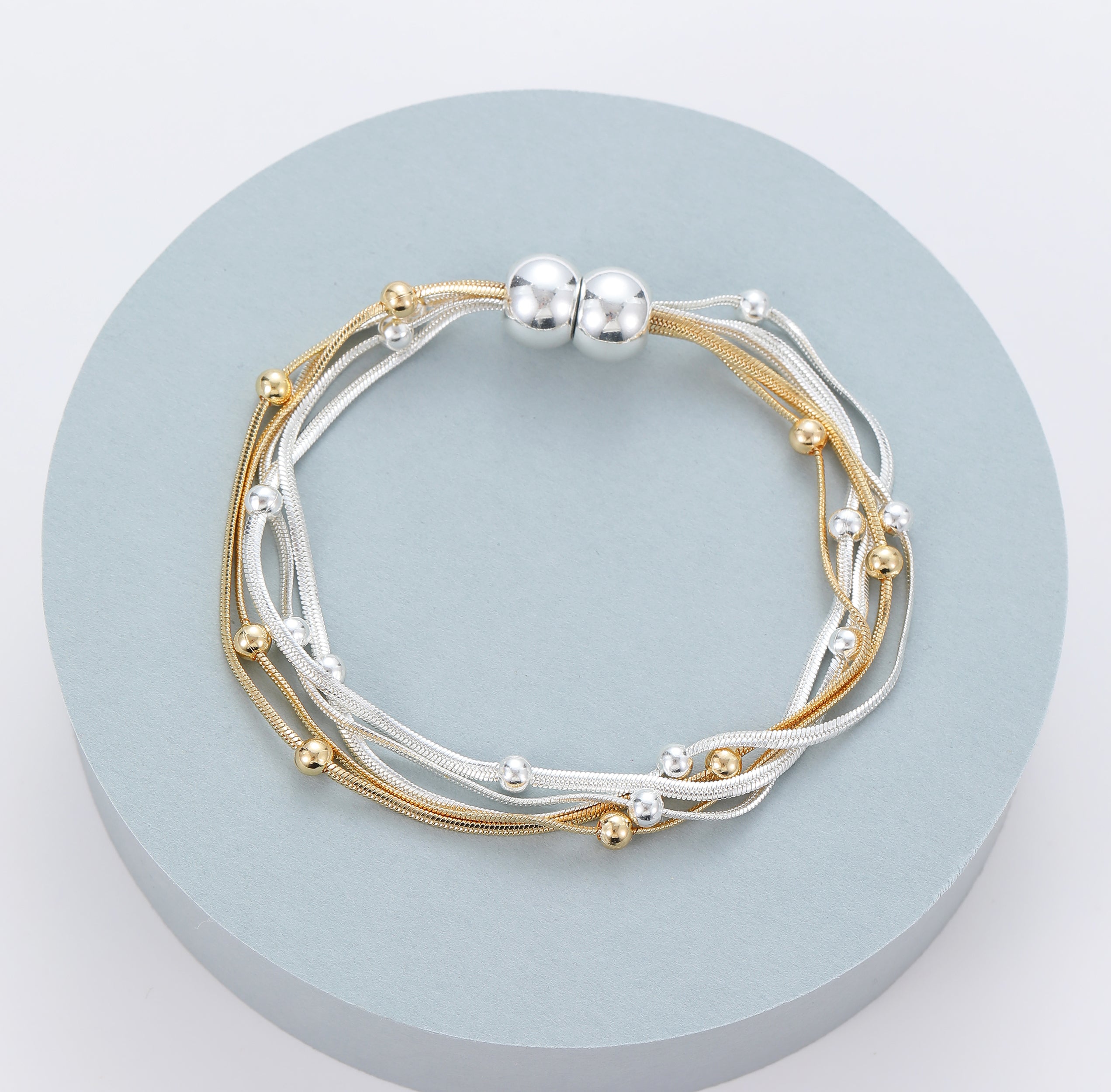 Magnetic bracelet with gold and silver multi-row bead segments