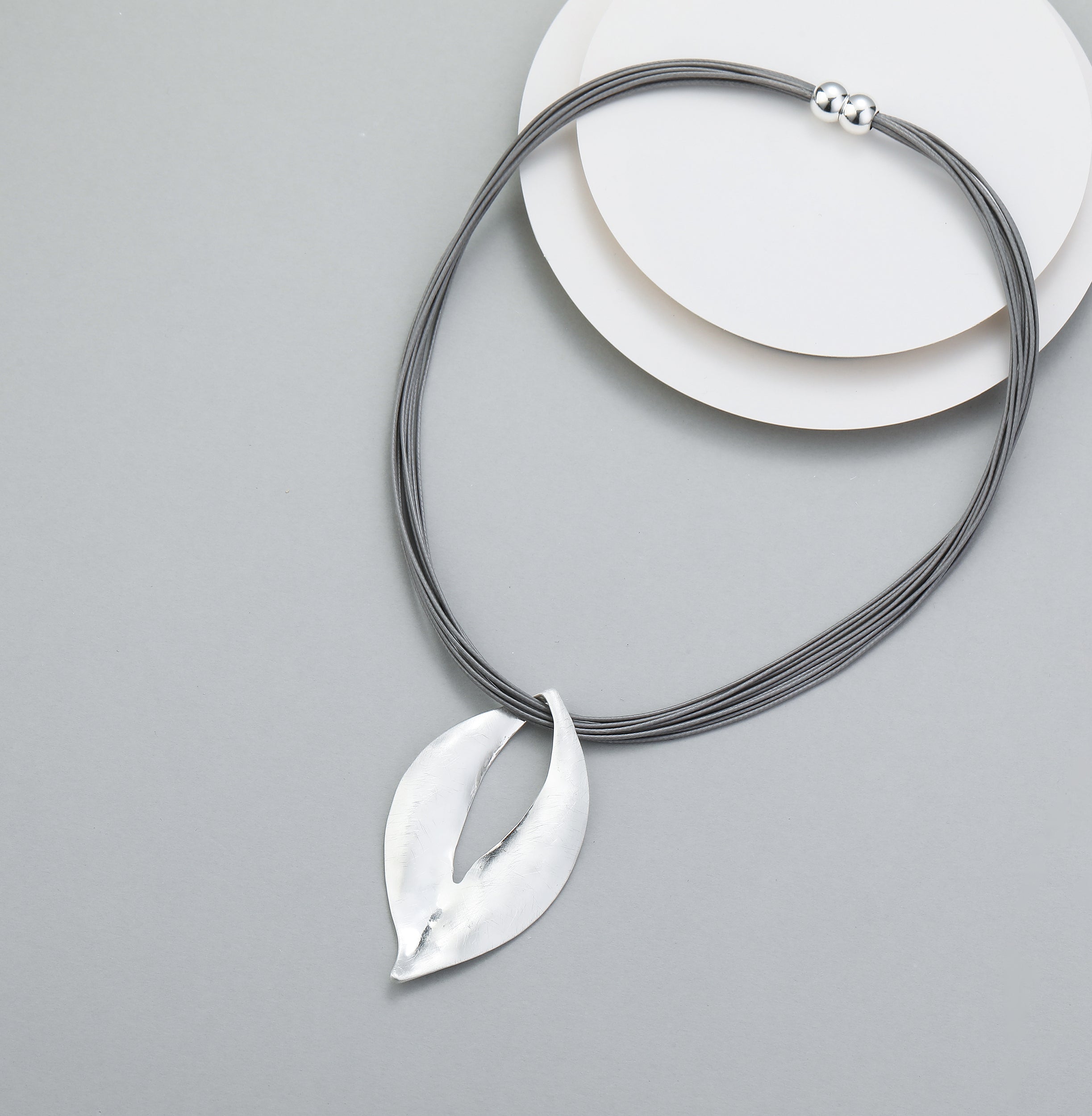 Short necklace, with silver open-leaf pendant and magnetic opening/closure  - on leather strands