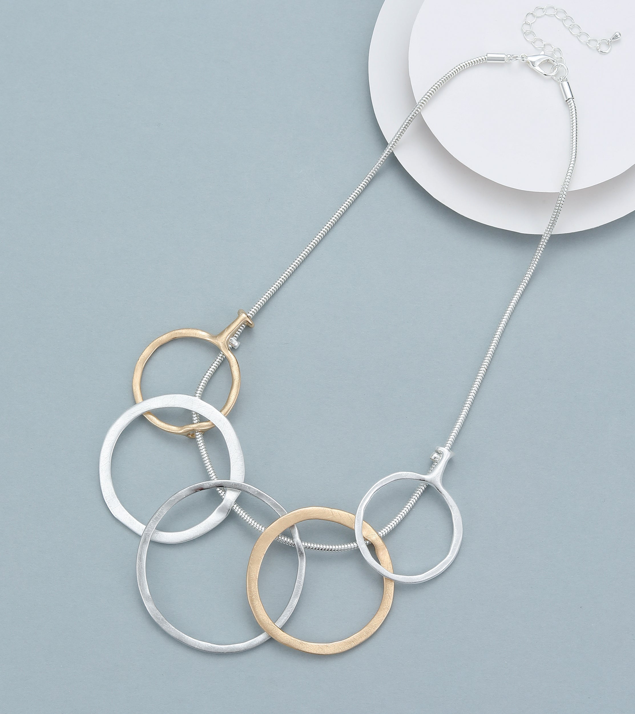 Short necklace, with matte silver, gold and grey open-circle rings - on a silver chain