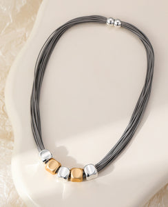 Short magnetic necklace, with silver and gold cubed stations