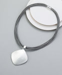 Short necklace, with matte silver square pendant drop and magnetic opening/closure  - on leather strands