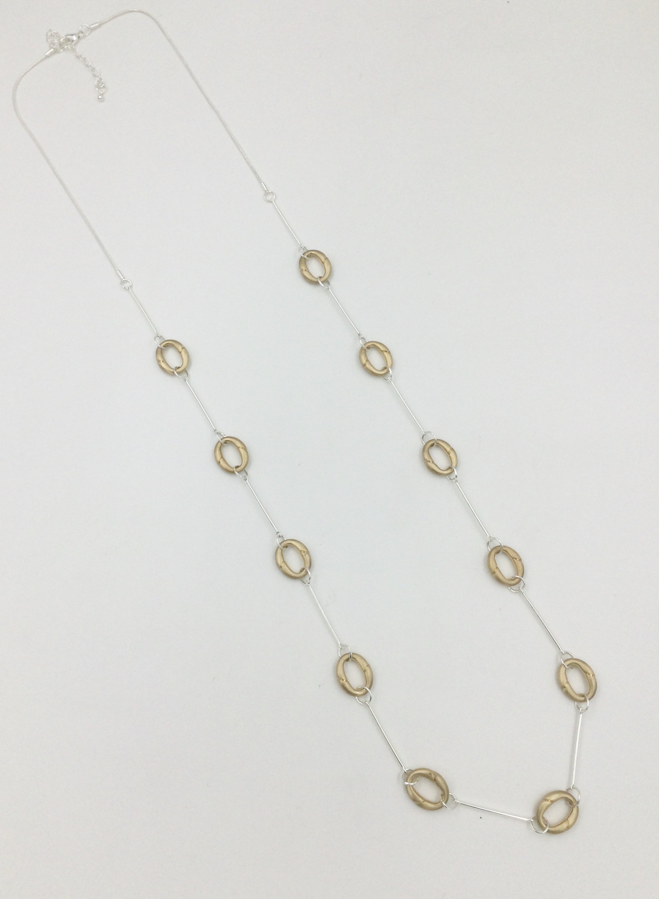 Long necklace, with interlinked matte gold open-circular stations - on a silver chain