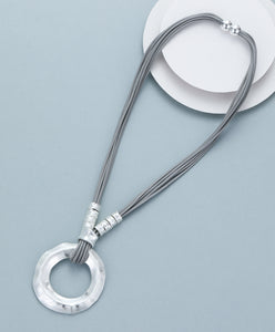 Short necklace, with silver-toned open circular pendant and magnetic opening/closure  - on leather strands