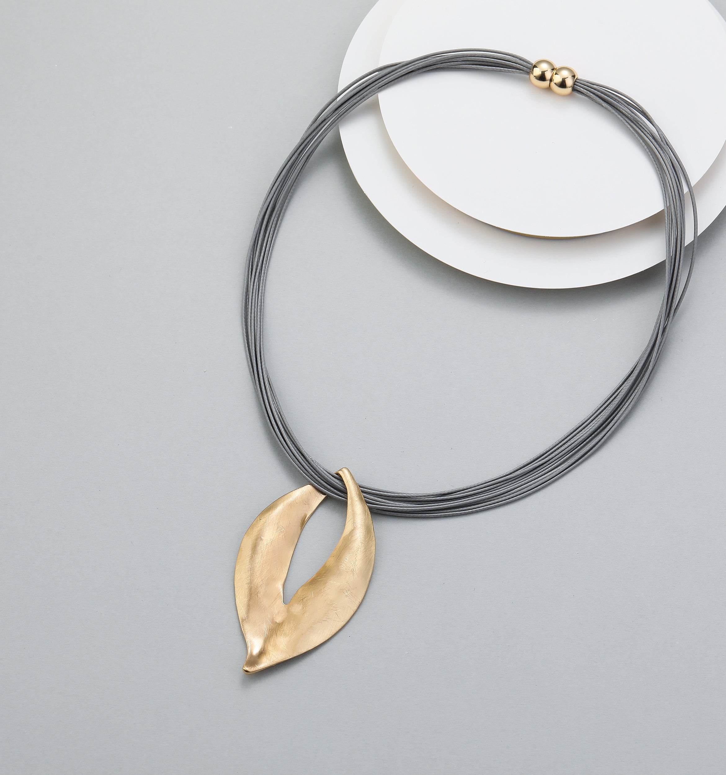 Short necklace, with gold open-leaf pendant and magnetic opening/closure  - on leather strands