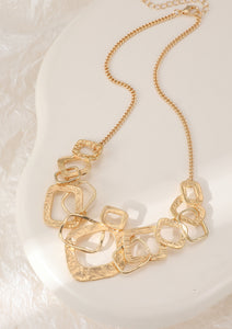 Short necklace, with yellow gold, battered metal interlinked squares