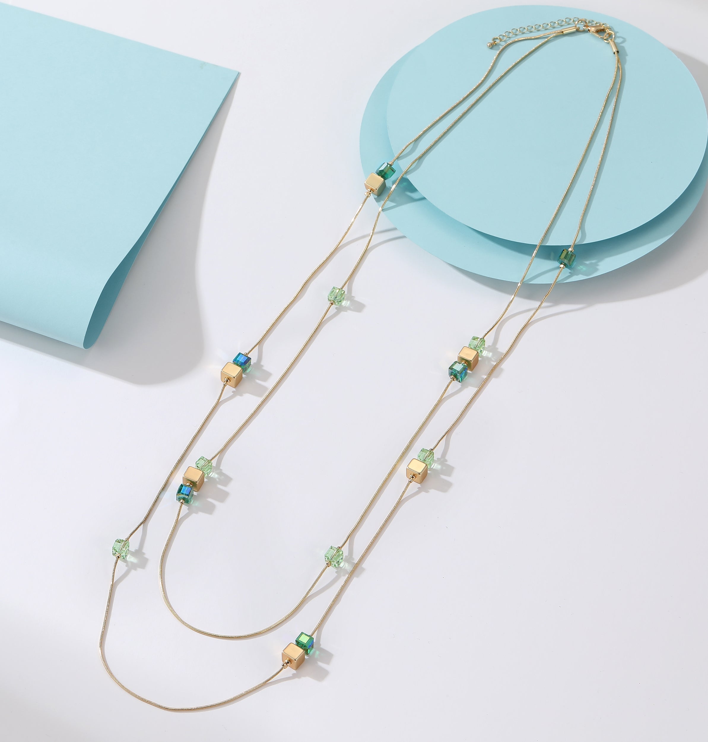 Long necklace, with two-row matte gold, sea blue and sage green polished-glass stations - on a gold chain