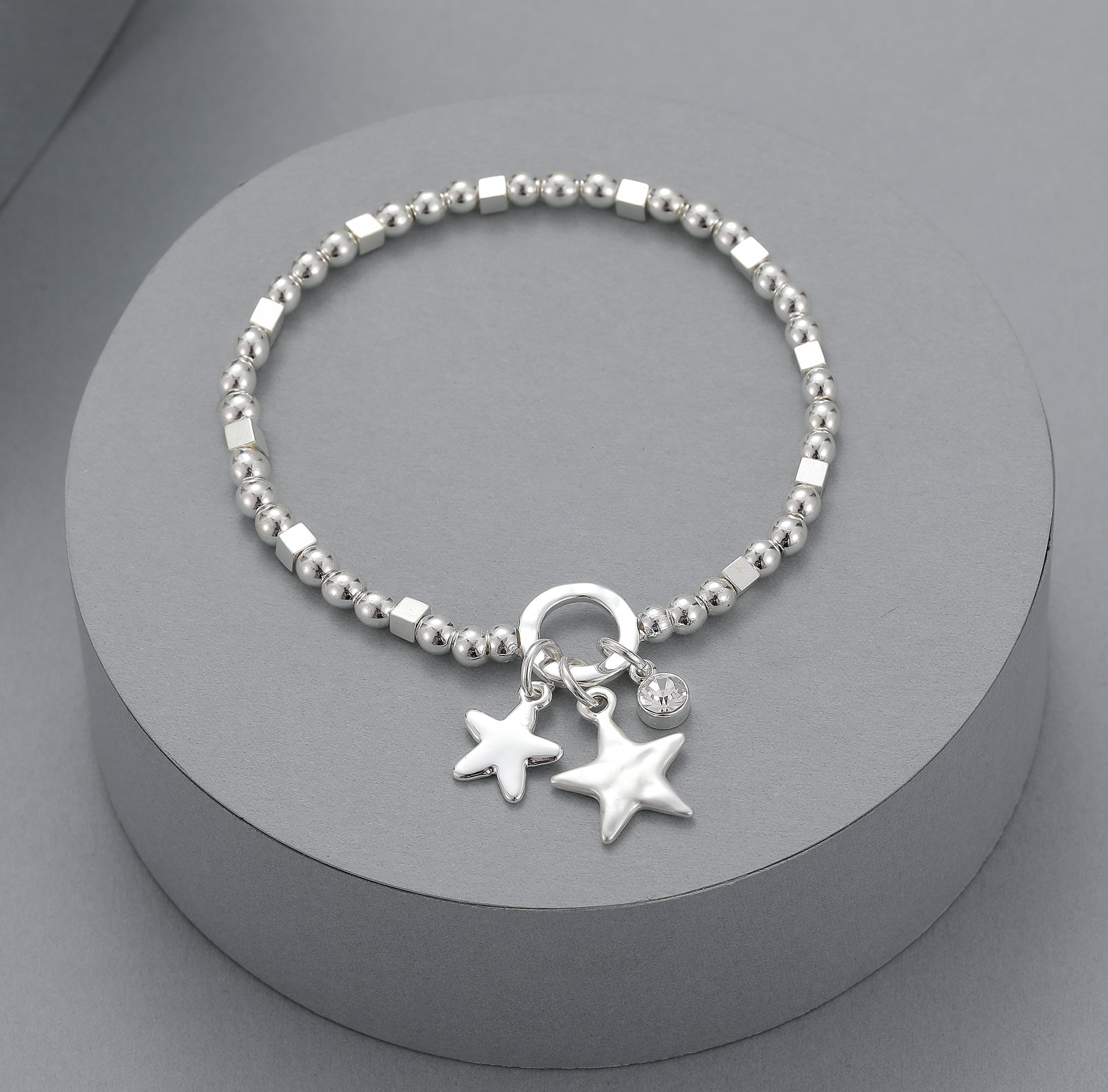 Silver elasticated bracelet with star motif