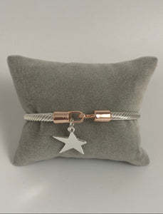 Twisted metal torque bangle with hanging star motif